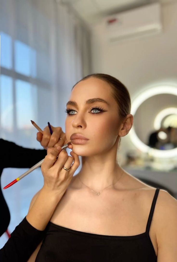 Soft glam makeup application with lip liner in the studio